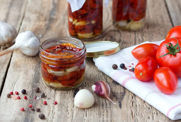 Dried and fresh tomatoes on old wooden table — Stock Photo, Image