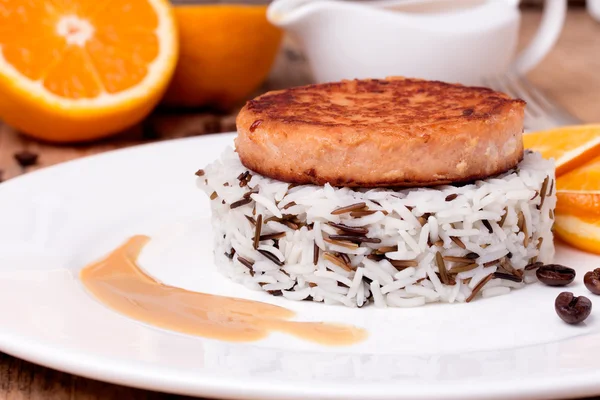 Beyaz tabakta karışık pişmiş pirinç somon madalyon