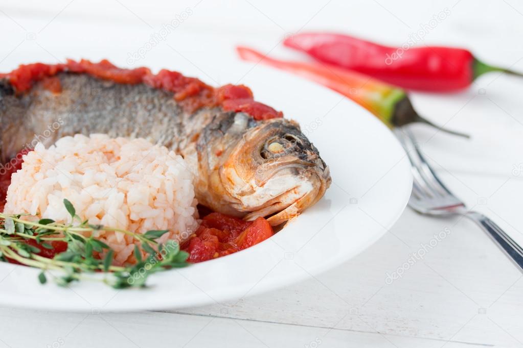 Steamed sea bass in tomato sauce with chili pepper.