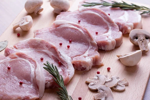 Pork tenderloin with champignon, rosemary, bay leaves and pepper — Stock Photo, Image