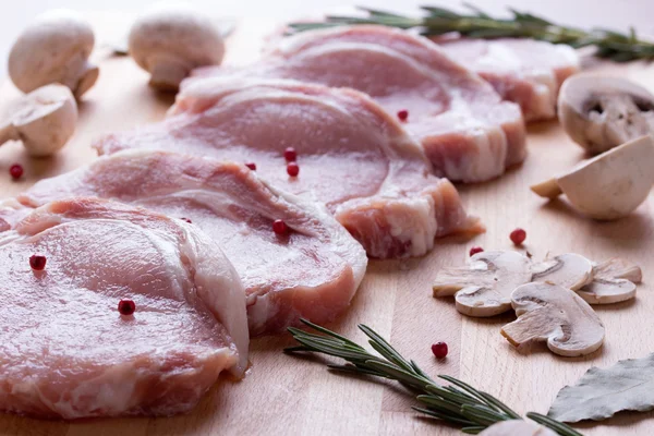 Pork tenderloin with champignon, rosemary, bay leaves and pepper — Stock Photo, Image