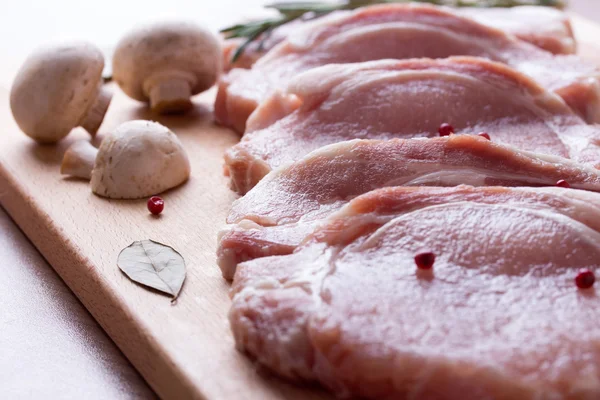 Pork tenderloin with champignon, rosemary, bay leaves and pepper — Stock Photo, Image