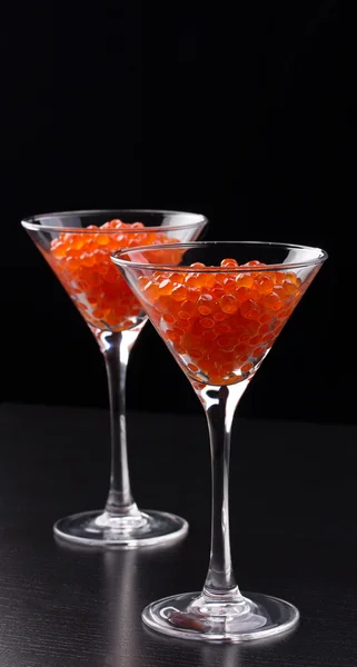 Red caviar in wineglasses on black background — Stock Photo, Image