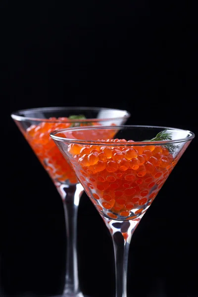 Red caviar in wineglasses on black background — Stock Photo, Image