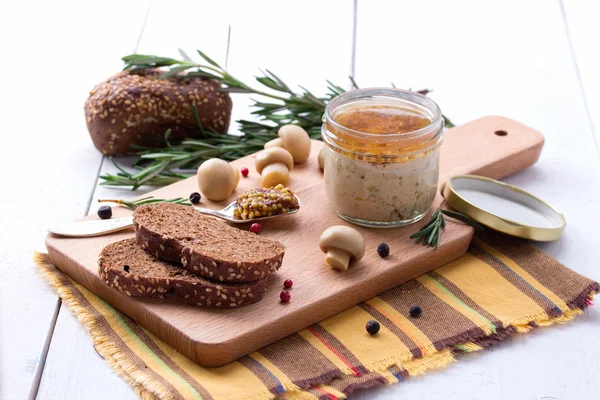 Chicken pate in jar and sliced bread with mustard — Stock Photo, Image