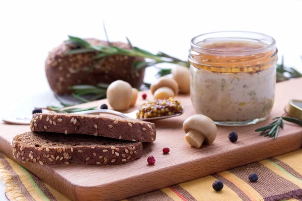 Chicken pate in jar and sliced bread with mustard — Stock Photo, Image