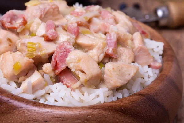 Chicken stew with rice in wooden bowl. — Stock Photo, Image