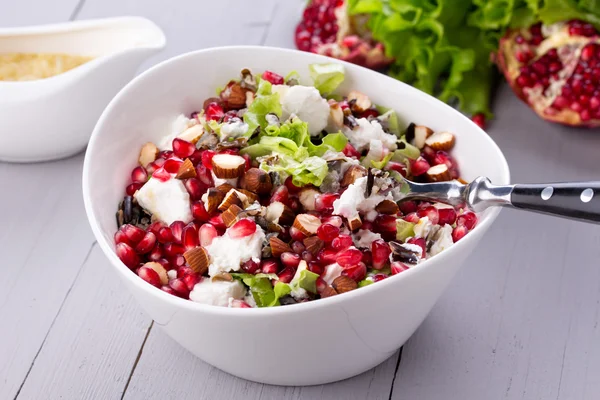 Healthy salad with pomegranate seeds, almond, feta cheese and black rice — Stock Photo, Image