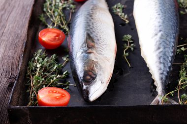 Eski siyah metalik fırın tepsisindeki ham uskumru