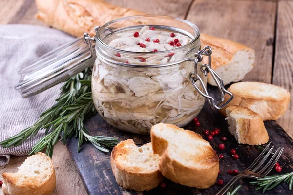 Chicken pate in glass jar and toast bread on rustic kitchen board — Stock Photo, Image
