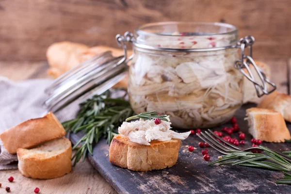 Chicken pate in glass jar and toast bread on rustic kitchen board — Stock Photo, Image
