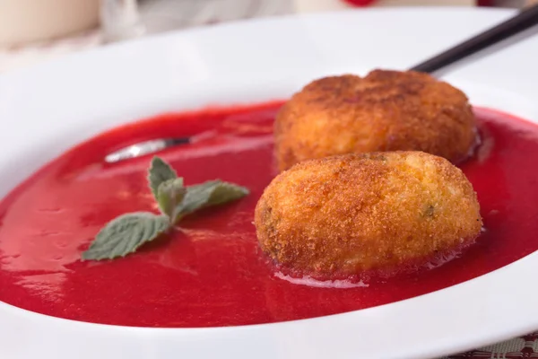 Strawberry soup with italian fried rice balls arancini. — Stock Photo, Image
