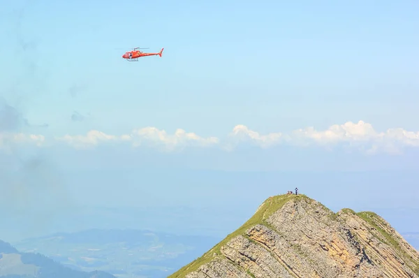 Helicopter in flight over the Swiss mountains.