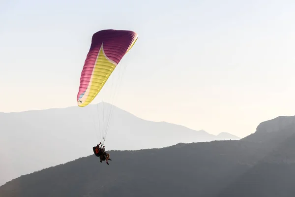 Paragliding flight in the air over the mountains. Drome, France.