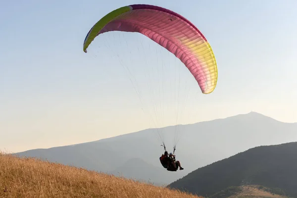 Paragliding flight in the air over the mountains. Drome, France.