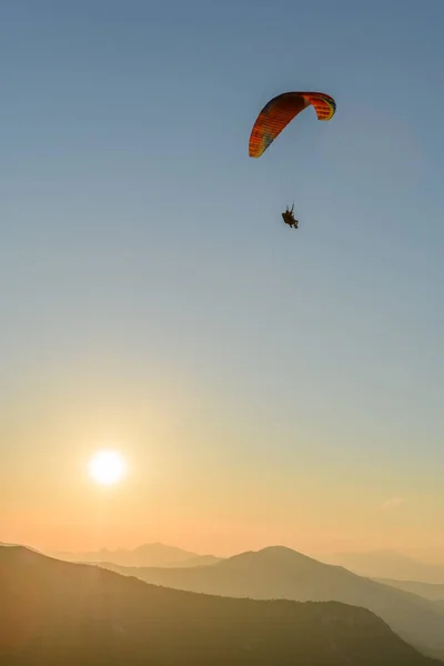 Paragliding flight in the air over the mountains. Drome, France.