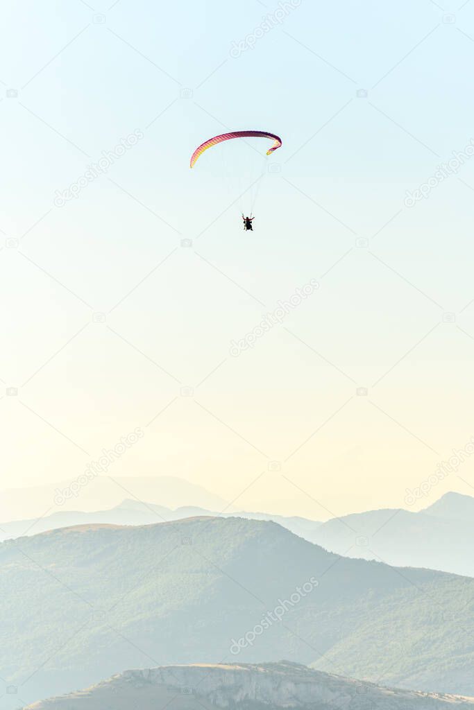 Paragliding flight in the air over the mountains. Drome, France.