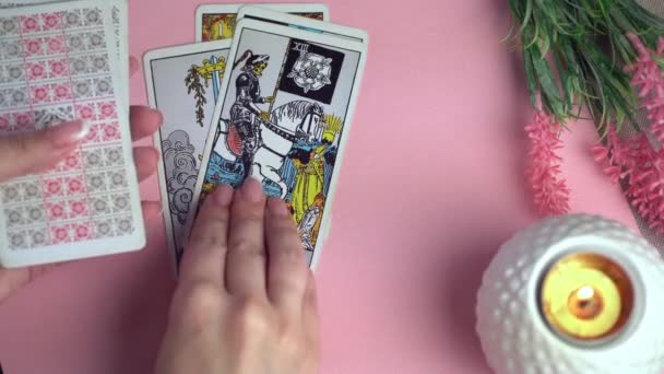 Tarot cards on table near burning candles. Fortune reading and forecasting. — Stock Video