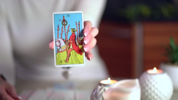 Tarot cards on table near burning candles. Fortune reading and forecasting. — Stock Video