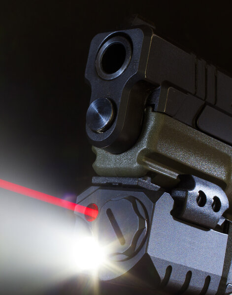 Red laser coming from a handgun weaponlight