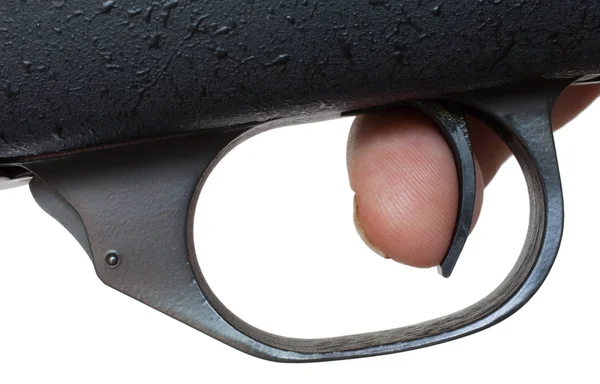 Палец на спусковом крючке оружия — стоковое фото