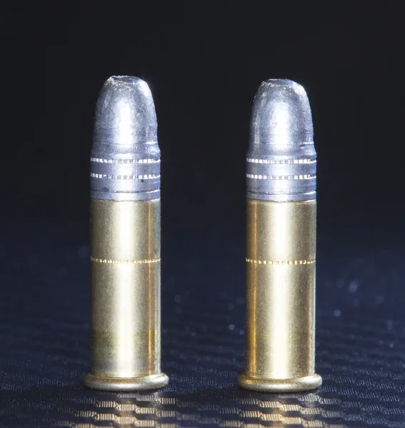 Lead ammo on graphite — Stock Photo, Image