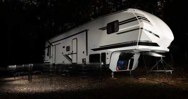 Fifth wheel campsite at night with a fence at Falls Lake North Carolina