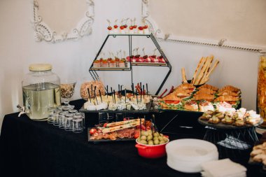 Bir etkinlik için aperatifler, sandviçler, peynirler ve içeceklerden oluşan açık büfe masası.