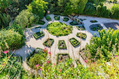 Medieval architecture of the village of La Garde-Adhemar in the Drome department of France on September 23, 2025. Botanical garden.