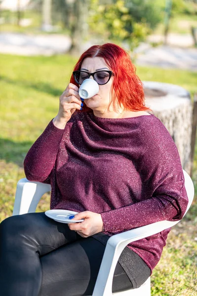 girl drinking coffee in the garden in the afternoon