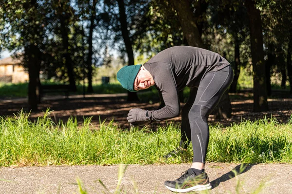 boy does physical activity in the park early in the morning