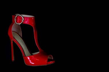 Siyah arka planda yaz sezonu için kırmızı deri sandalet.