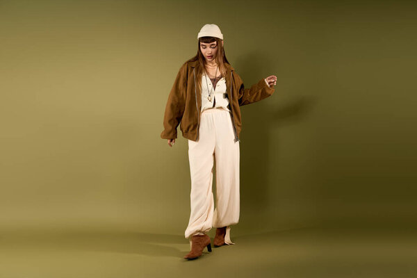 A young, pretty woman confidently poses in a chic outfit, displaying her unique fashion sense.