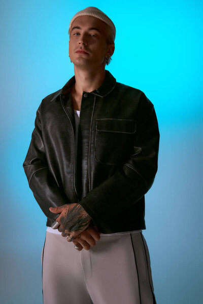 Handsome young man stands poised in a chic outfit, emanating style and confidence.