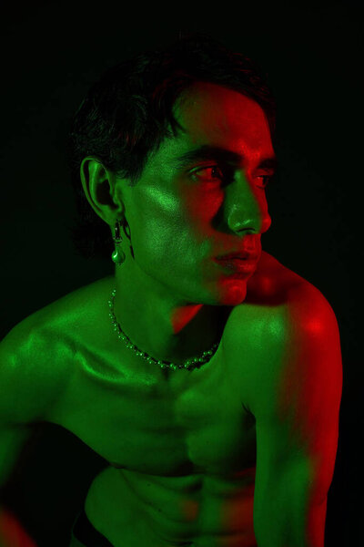 Handsome man showcases unique style with striking colors and artistic visual elements.