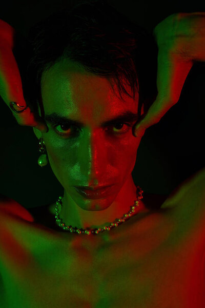 Handsome man exhibits unique style and creativity with striking colors and bold accessories.