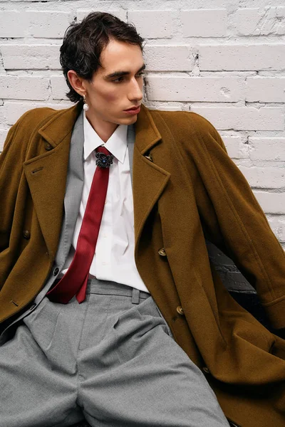 Uzun paltolu ve özel dikim pantolonlu şık bir adam şehirde karizma yayar..