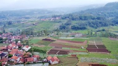 Drone videoları, dağ köyü manzaraları insanların evlerini ve büyük yeşil ağaçları gösteriyor.