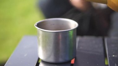 Metal bardak kullanarak bir fincan sıcak kahve yapmak. Yaşam tarzı, seyahat ve açık hava aktiviteleri için uygun..