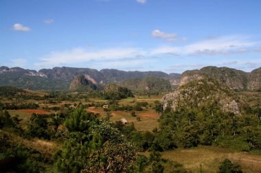 View of Vinales Valley, in the province of Pinar del Rio, Cuba. Landscape with the mogotes, in geomorphology, is a prominent, isolated terrain elevation rounded in the shape of a dome and farm fields.