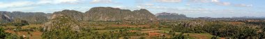 View of Vinales Valley, in the province of Pinar del Rio, Cuba. Landscape with the mogotes, in geomorphology, is a prominent, isolated terrain elevation rounded in the shape of a dome and farm fields.
