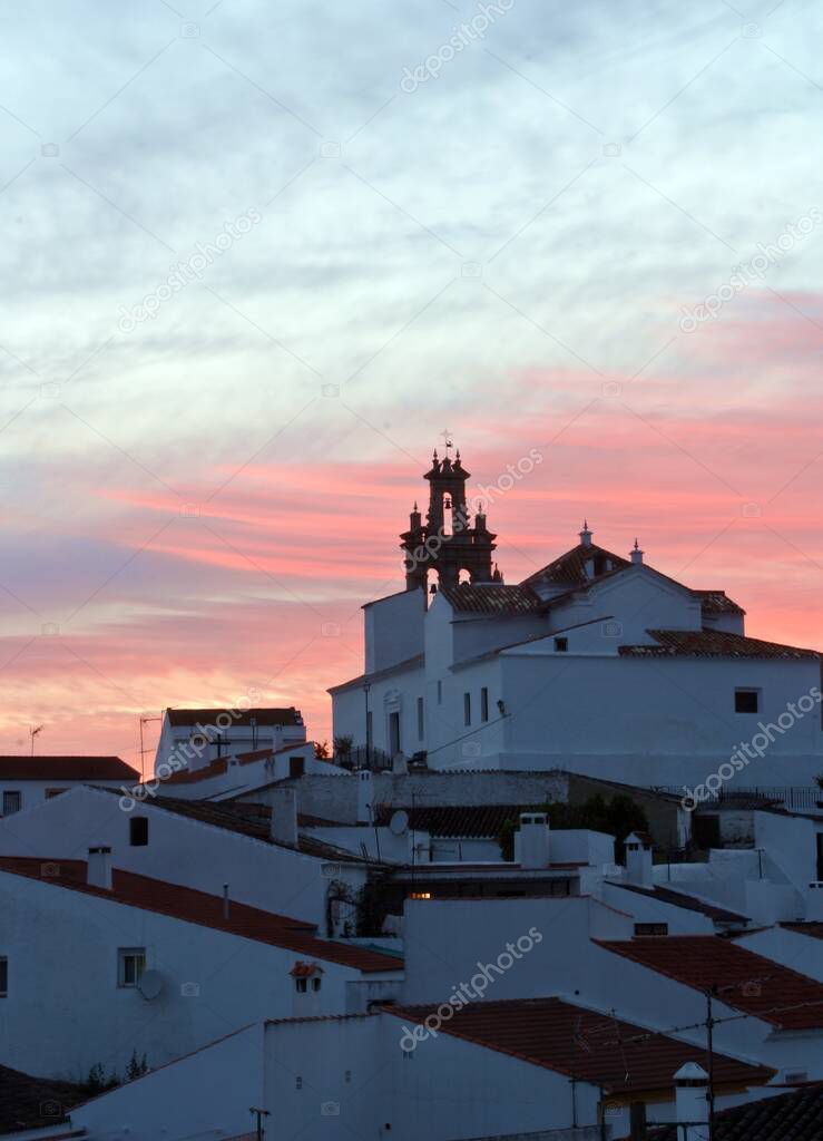 Bell tower of the Church of Our Lady of the Flowers at sunset in Sanlucar de Guadiana, Huelva, Spain.
