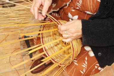 Traditional cane handicraft in Sanlucar de Guadiana, Andalusia, Spain. Real work, making baskets. clipart