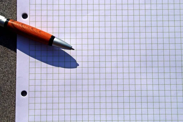 Leave the message. Squared notebook sheet with a pen.