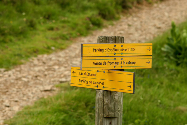 Borce, France; 06 15 2016. Yellow signs in the National Park of the Pyrenees to get to a parking and indications to get to Estanes lake.