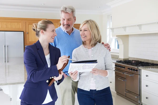 Female Realtor Showing Mature Couple Around House For Sale — Stock Photo, Image