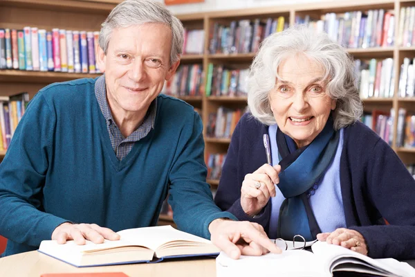 Mature Student Working With Teacher In Library — Stock Photo, Image