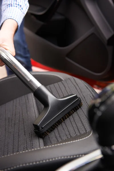 男が車内清掃中に車の座席機で掃除 — ストック写真