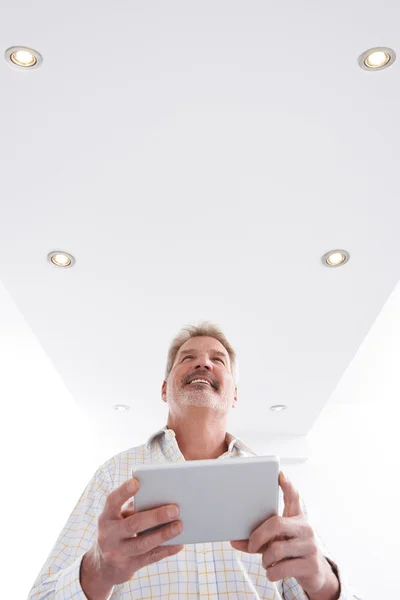 Man Controlling Lighting With App On Digital Tablet — Stock Photo, Image