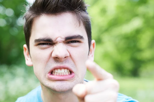 Cabeza y hombros al aire libre Retrato de hombre joven enojado — Foto de Stock